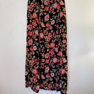Woman’s full length maxi skirt, black with multicolored floral design.